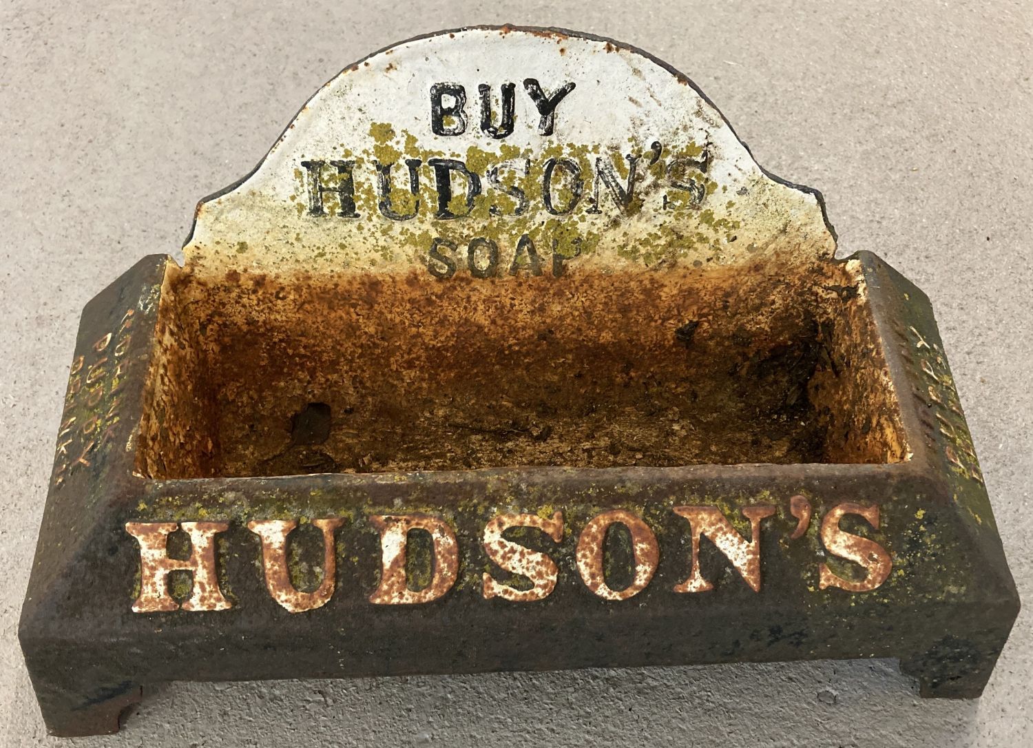 A heavy cast iron advertising Hudson's Soap "Drink Puppy Drink" dog water trough.