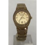 A ladies modern wristwatch by Fossil. Gold tone case with clear stone decoration.