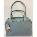 A Radley duck egg blue leather shoulder bag with bag charm.