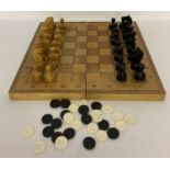 A vintage chess set with wooden folding box/board and playing pieces.