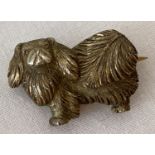 A silver brooch in the shape of a Pekingese dog. Marked silver to back.