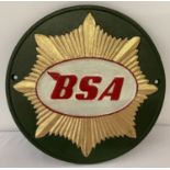A circular painted cast iron "BSA" wall hanging plaque.