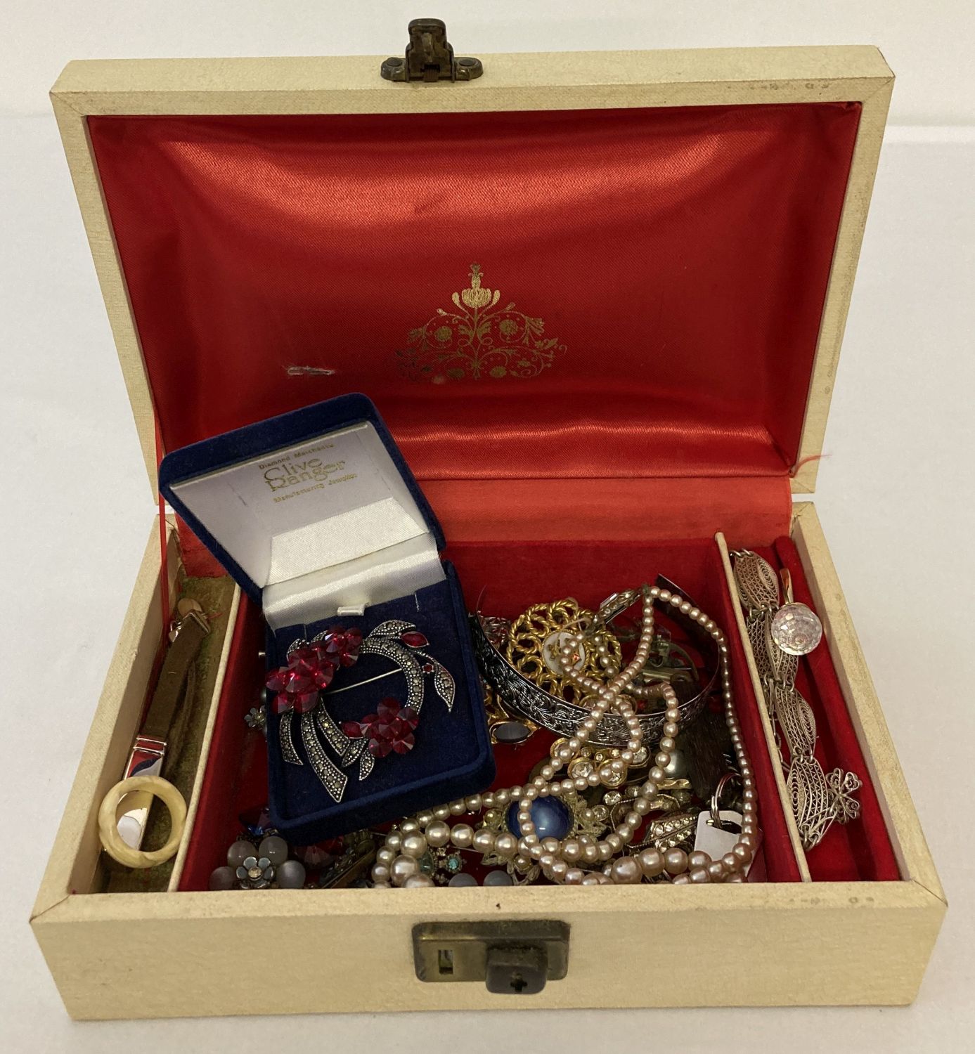 A vintage jewellery box containing a small quantity of vintage costume jewellery.