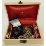 A vintage jewellery box containing a small quantity of vintage costume jewellery.