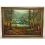 A large gilt framed oil on canvas of a autumnal woodland scene.