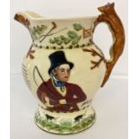 A Crown Devon "John Peel" ceramic jug. Fox handle with hunting scene decoration. Verse to front.