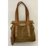A Lottusse soft brown leather and suede shoulder bag with front tassel bag charm.