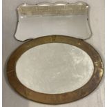 2 vintage wall hanging mirrors. A bevel edged shaped mirror with a brass framed oval mirror.