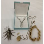 A small collection of costume jewellery to include a gold plated oval locket.