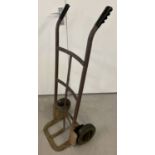 A metal framed sack barrow with rubber tyres and plastic handle grips.