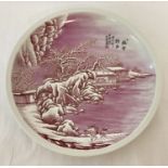 A signed, hand painted pink and white Chinese ceramic plate depicting a snow scene.