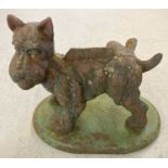 A large vintage heavy cast iron doorstop/boot scraper in the form of a cocked leg Scottie dog.