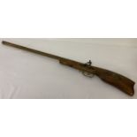 A reproduction ornamental rifle with decoration to handle and hanging ring to back.