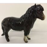 A Beswick ceramic Shetland Pony figurine (Woolly Shetland Mare), model #1033.