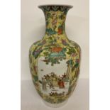 A very large Chinese ceramic vase in yellow ground glaze with lotus flower design.