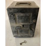 A Victorian cast iron safe painted black with original key. Carry handles to both top and side.