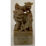 A Chinese soapstone square shaped seal with carved foo dog detail.