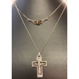 A silver curb chain with modern style crucifix together with a fixed pendant necklace.