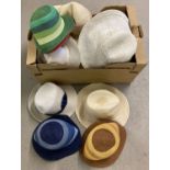 A box of assorted vintage ladies summer hats.