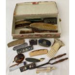 A box of vintage hair combs, curling tongs and setting cream.
