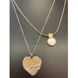 A "Foot Prints" heart shaped pendant with verse to reverse on a 18" fine curb chain.
