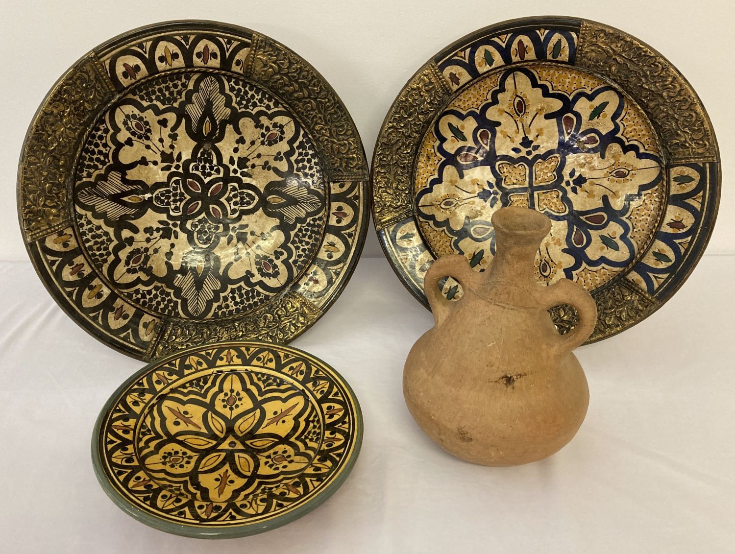 4 items of North African pottery, comprising: 2 hand painted and glazed bowls with metal applique,