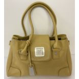 A Jasper Conran soft mustard coloured leather shoulder bag with large metal clasp.