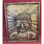 A large heavy metal wall hanging plaque depicting Buddha.