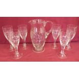 A set of six crystal wine glasses with a matching jug with diamond cut pattern.