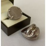 A modern design dome style silver ring together with a 1962 sixpence set ring with decorative mount.