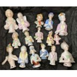 A collection of 16 vintage ceramic half dolls, in varying sizes.