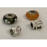 4 charm bracelet beads. 2 glass pandora beads together with a clear stone set bead and a elephant.