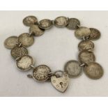 A bracelet made from 16 silver threepence coins with silver padlock clasp and safety chain.