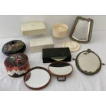 A box containing vintage vanity boxes, vanity mirrors and a powder puff boxes.