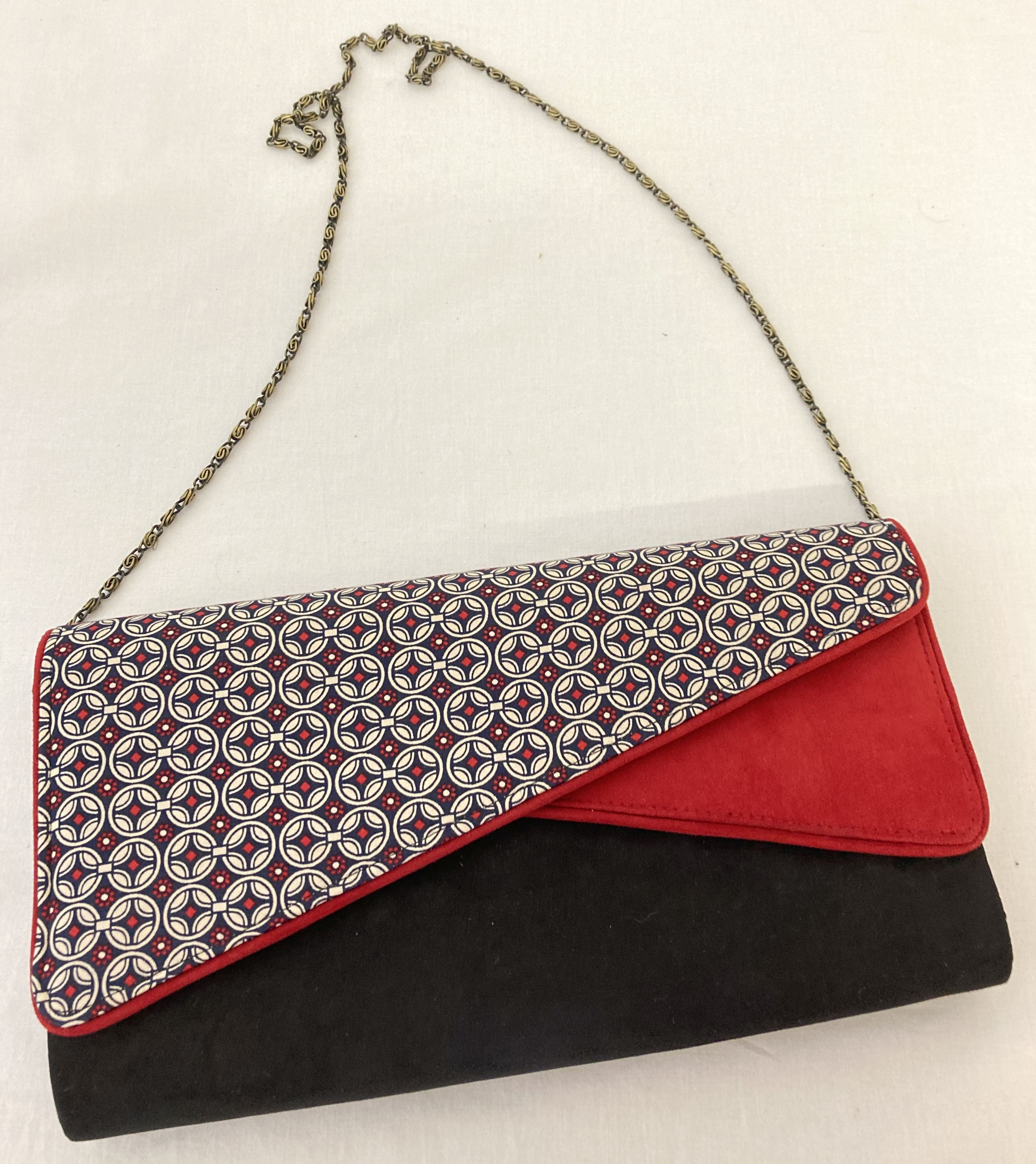 A Ruby Shoo faux suede clutch/shoulder bag in red, black and geometric print. - Image 2 of 5