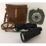 A pair of West German Stern binoculars together with a slate mounted Daymaster barometer.