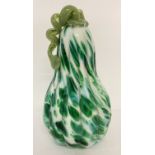 A white and green art glass figurine of a gourd.