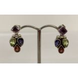 A pair of multi gem set silver modern design drop earrings.