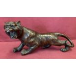 A hollow bronze figurine of a roaring tiger.