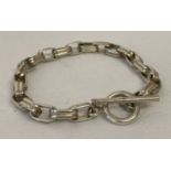 A decorative silver belcher chain bracelet with T bar clasp. Marked 925 to fixing.