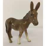 A Beswick ceramic donkey foal figurine, model #2110.