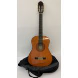 An Eko CS-5, ¾ sized classical guitar, complete with soft zip-up case.