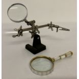 A vintage desk top adjustable magnifying glass.