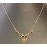 A 9ct gold necklace with filigree heart decoration and central drop filigree heart.