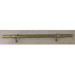 An antique long brass foot rest/hand rail, with mounting brackets.