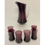 A vintage Polish aubergine coloured glass water jug and 6 matching tumblers.