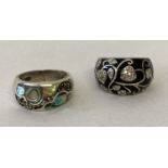 2 silver dome style dress rings. A black enamel floral design set with clear stones.