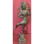 A large vintage hollow spelter figurine of the Hindu god Shiva standing atop the demon of ignorance.