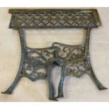 A pair of cast iron bench ends and back plate. Floral and scroll decoration to ends.
