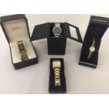 A collection of 4 boxed quartz watches in gold and silver tones.